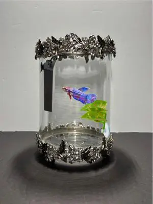 A glass jar with a fish inside of it