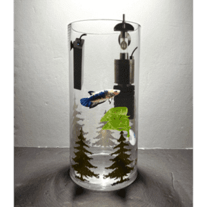 A glass with trees and other things inside of it
