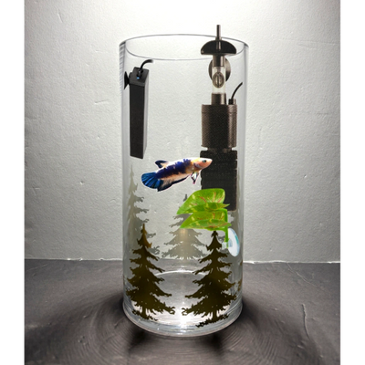 A glass with trees and other things inside of it